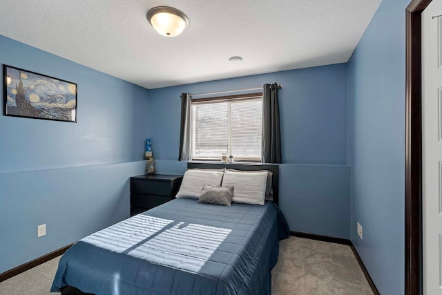 bedroom with carpet floors and a textured ceiling