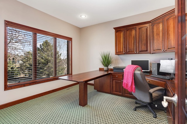 office with recessed lighting, built in desk, light colored carpet, and baseboards