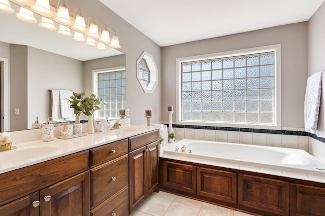 bathroom with tile patterned floors, a healthy amount of sunlight, and a sink