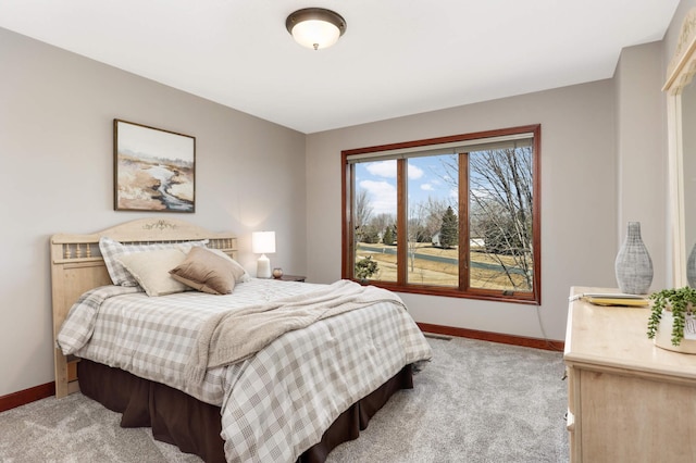 bedroom with visible vents, light colored carpet, and baseboards