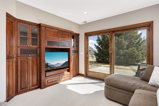 living area with light colored carpet