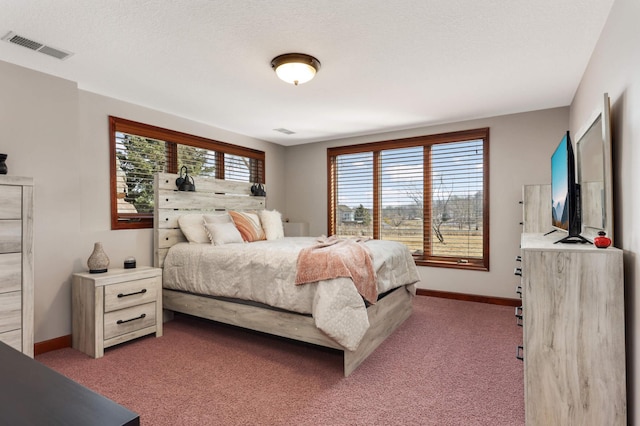 bedroom featuring visible vents, light carpet, and baseboards