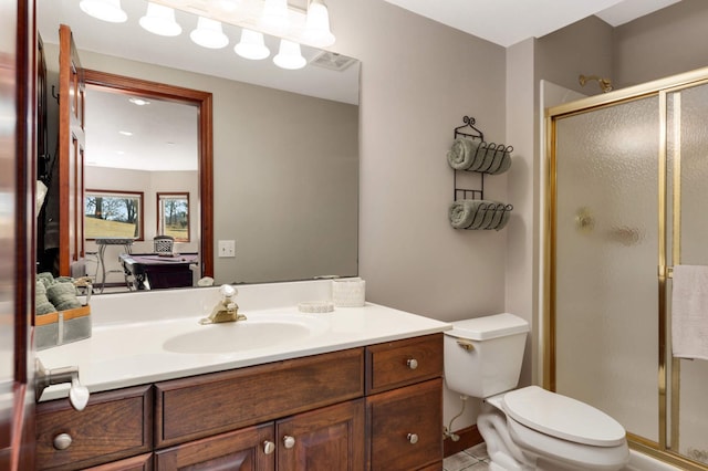 ensuite bathroom with vanity, toilet, a stall shower, and ensuite bathroom