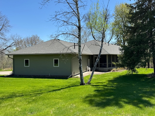 12326 Falk Trl, Northfield, MN 55057 - back of property with a sunroom, a yard, and a shingled roof