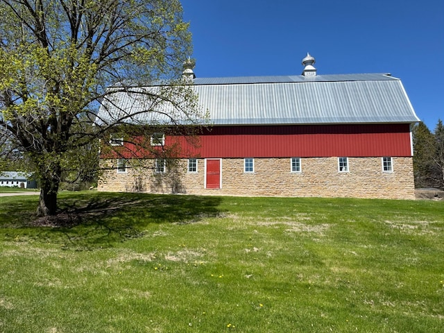 12326 Falk Trl, Northfield, MN 55057 - view of side of home featuring stone siding, a yard, and metal roof