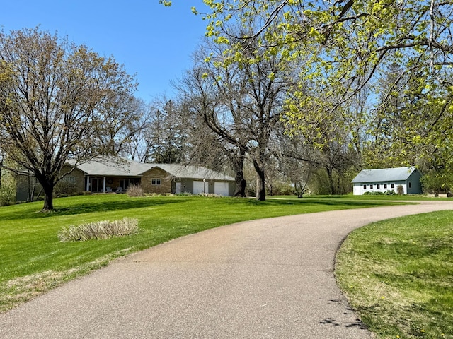 12326 Falk Trl, Northfield, MN 55057 - view of home's community featuring a lawn, asphalt driveway, and an attached garage