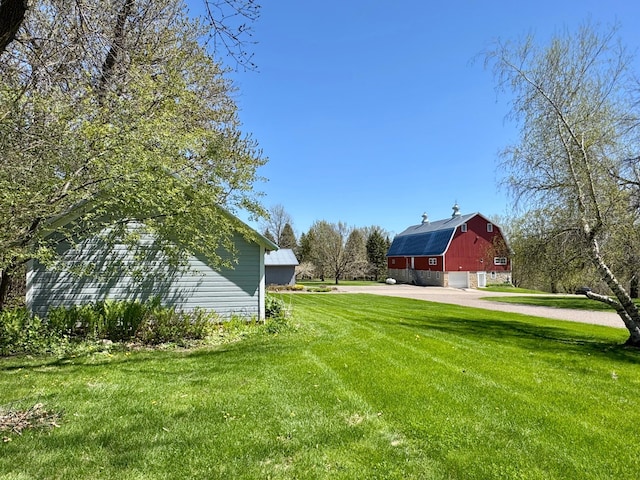 12326 Falk Trl, Northfield, MN 55057 - view of grassy yard with a barn, a garage, driveway, and an outdoor structure
