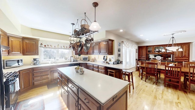 12326 Falk Trl, Northfield, MN 55057 - kitchen featuring black appliances, light countertops, light wood-style floors, pendant lighting, and recessed lighting