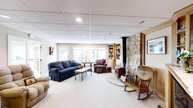 12326 Falk Trl, Northfield, MN 55057 - carpeted living area with a wood stove, a paneled ceiling, and recessed lighting