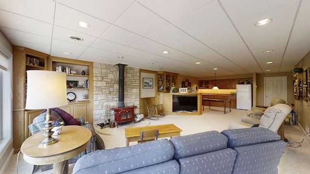 12326 Falk Trl, Northfield, MN 55057 - living room with a wood stove, recessed lighting, built in features, baseboards, and light colored carpet