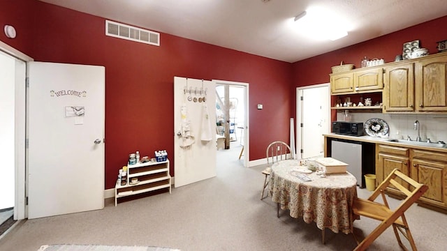 12326 Falk Trl, Northfield, MN 55057 - kitchen with a sink, black microwave, light carpet, dishwashing machine, and open shelves