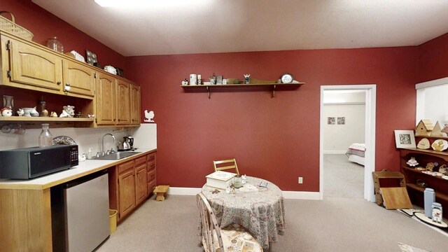 12326 Falk Trl, Northfield, MN 55057 - kitchen featuring open shelves, black microwave, fridge, a sink, and light carpet