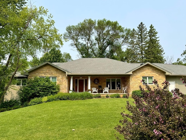 12326 Falk Trl, Northfield, MN 55057 - ranch-style home featuring stone siding, a porch, a front yard, and a shingled roof