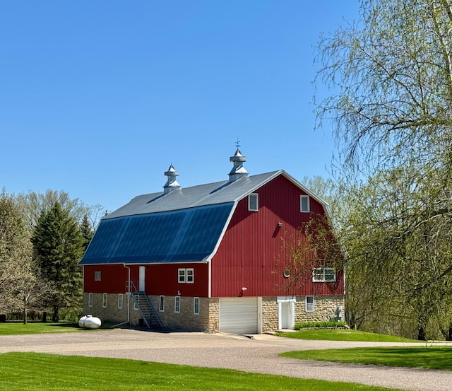 12326 Falk Trl, Northfield, MN 55057 - view of side of property featuring a barn, a gambrel roof, driveway, an outbuilding, and a lawn