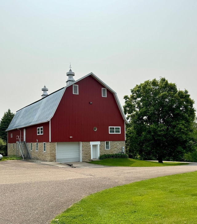 12326 Falk Trl, Northfield, MN 55057 - view of home's exterior with a barn, driveway, an outbuilding, a lawn, and a gambrel roof