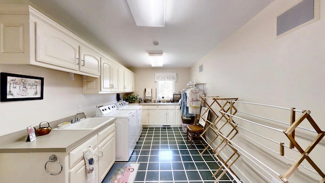 12326 Falk Trl, Northfield, MN 55057 - washroom with washer and dryer, cabinet space, and dark tile patterned flooring