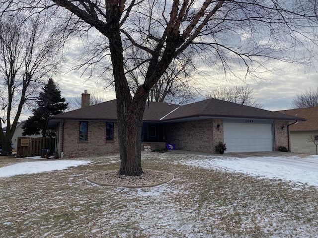 view of front of home featuring central AC unit and a garage