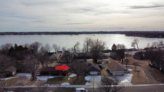 aerial view at dusk featuring a water view