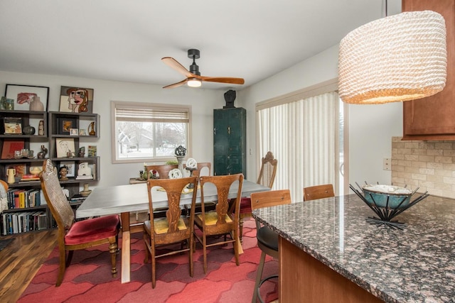 dining space with hardwood / wood-style floors and ceiling fan