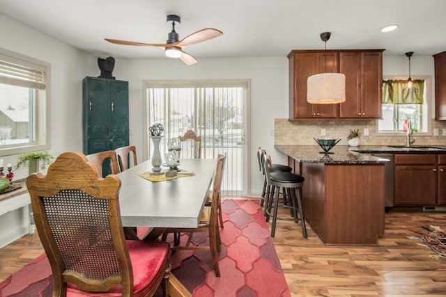 dining room featuring sink, ceiling fan, and hardwood / wood-style floors