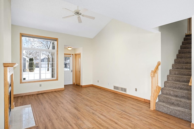 unfurnished living room featuring ceiling fan, light hardwood / wood-style flooring, and lofted ceiling