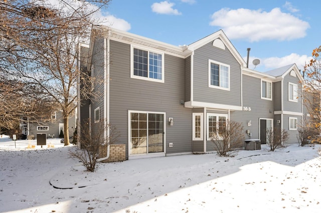 view of snow covered rear of property