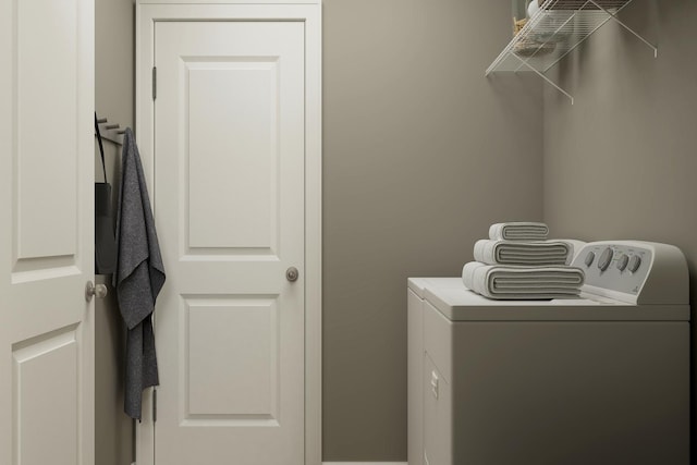 washroom featuring laundry area and washing machine and dryer