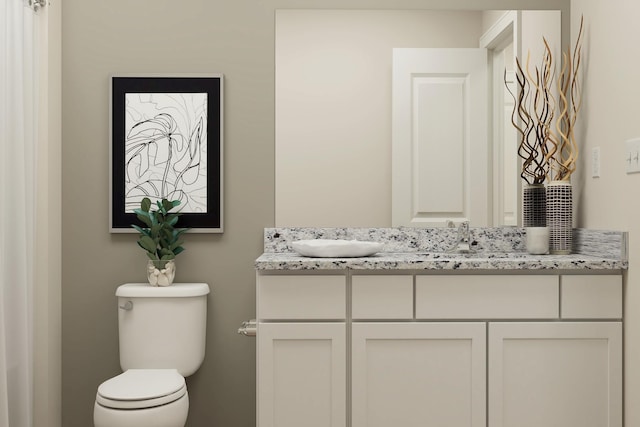 bathroom with a sink, toilet, and double vanity