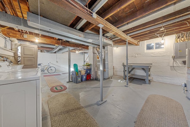 basement featuring washer and dryer, electric panel, and heating unit