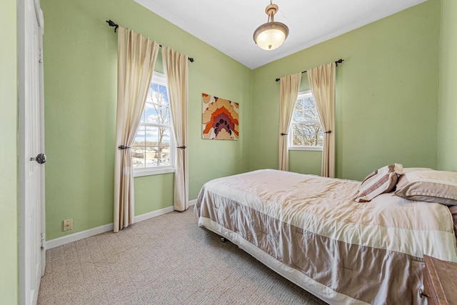 bedroom with light carpet and multiple windows