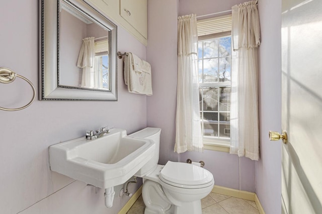 bathroom with toilet and tile patterned flooring