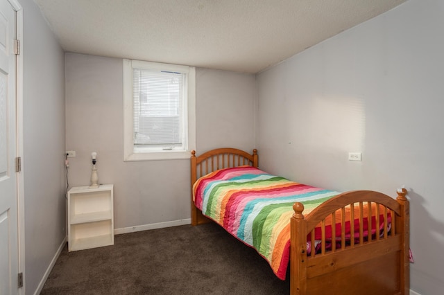 carpeted bedroom featuring a textured ceiling