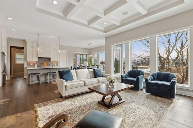 living room with beamed ceiling, coffered ceiling, and hardwood / wood-style floors