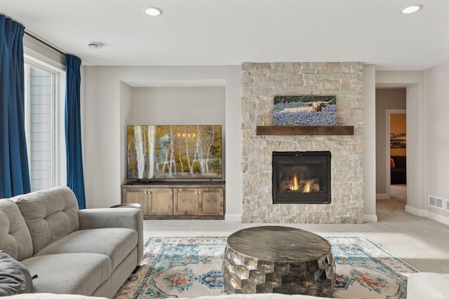 carpeted living room featuring a fireplace