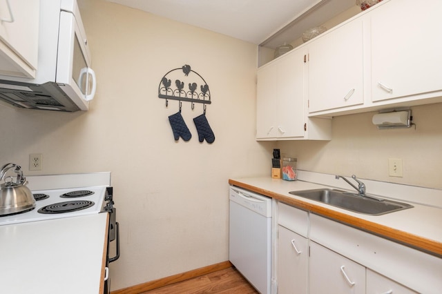 kitchen featuring light hardwood / wood-style floors, sink, white appliances, and white cabinets