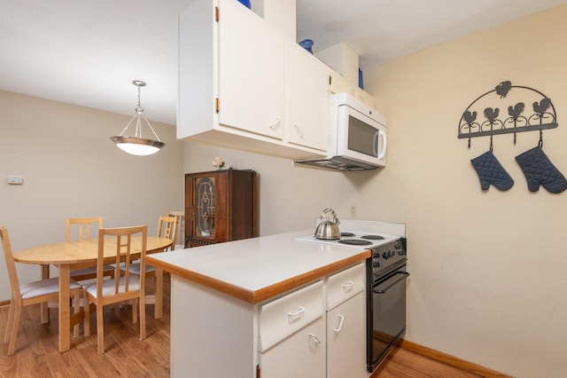 kitchen featuring white cabinetry, range with electric stovetop, light hardwood / wood-style floors, and decorative light fixtures