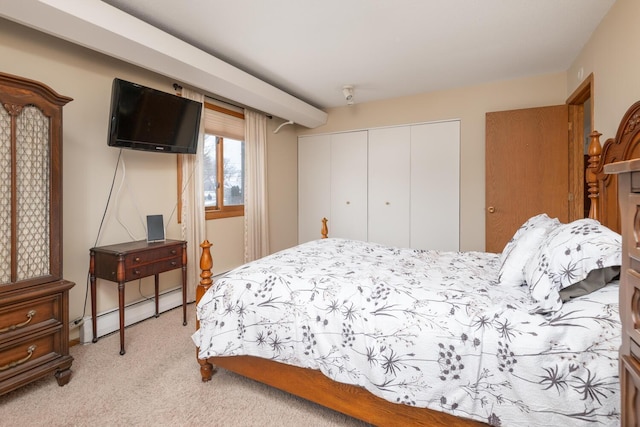 bedroom featuring light colored carpet, a baseboard heating unit, and a closet