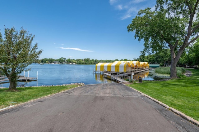 dock area featuring a water view and a yard