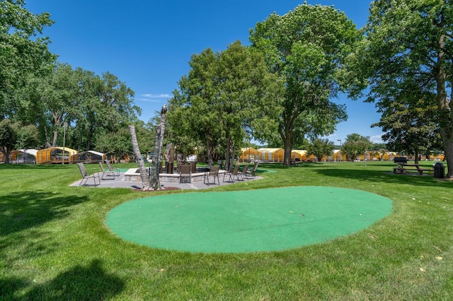 view of community with a patio and a yard