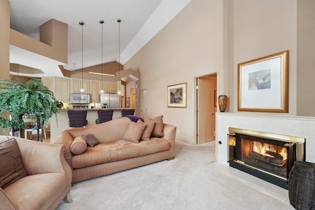 living room featuring high vaulted ceiling and light colored carpet