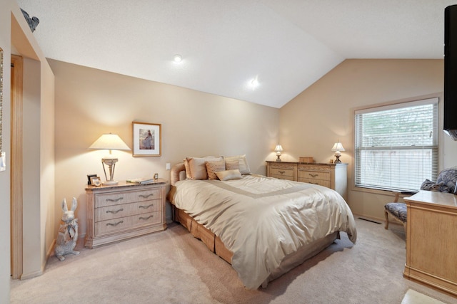 carpeted bedroom featuring vaulted ceiling