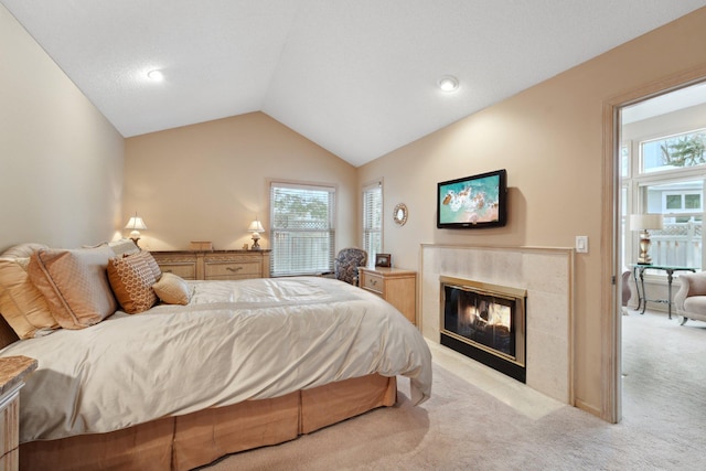 carpeted bedroom with lofted ceiling