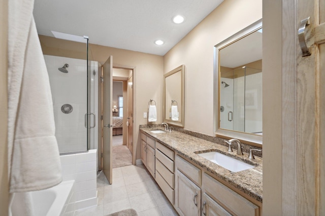 bathroom featuring tile patterned flooring, vanity, and a shower with shower door