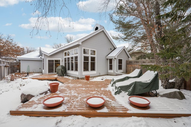 snow covered property featuring a wooden deck