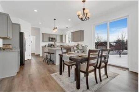 dining space featuring dark hardwood / wood-style flooring and a notable chandelier