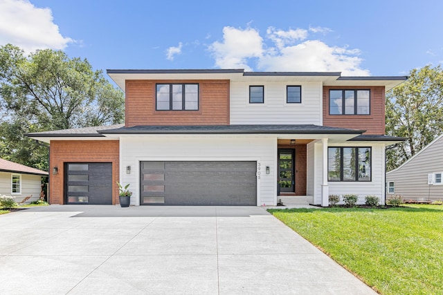 contemporary home with a garage and a front lawn