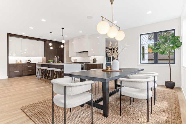 dining area featuring light hardwood / wood-style floors and sink