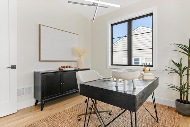 office with light hardwood / wood-style floors