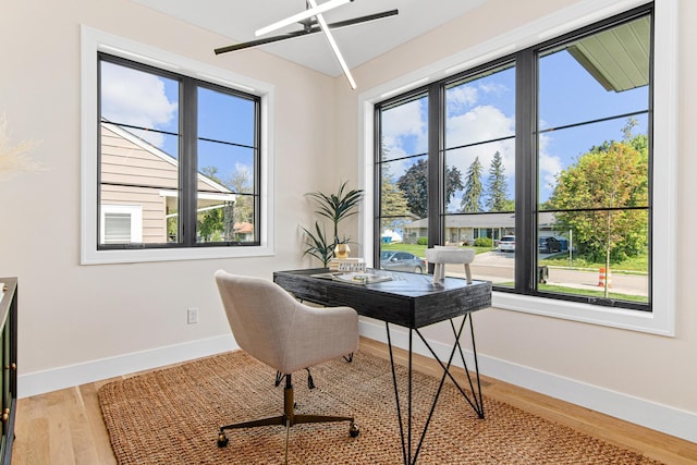 home office with hardwood / wood-style flooring