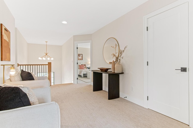 carpeted living room with a chandelier